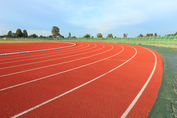 Running track over blue sky and clouds