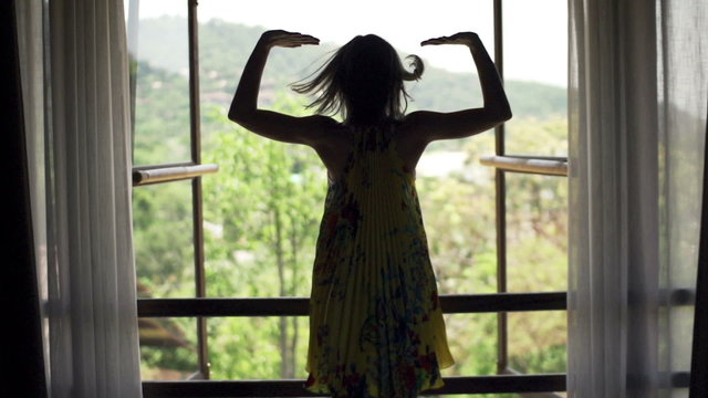 Young woman open window and admire view
