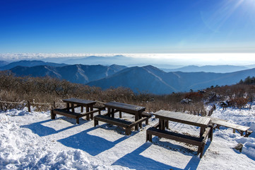 Wooden picnic tables with benches in winter,Deogyusan Mountains, South Korea.