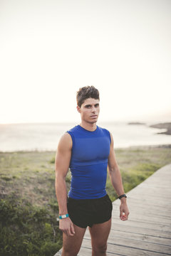 Spain, Ferrol, portrait of a jogger standing on boardwalk