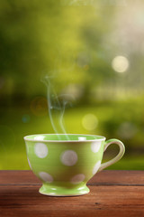 a cup of coffee or tea on garden background