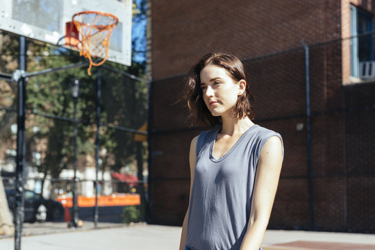 USA, New York City, Manhattan, young woman standing on a playground
