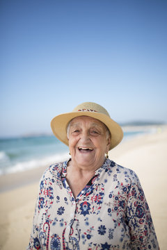 Spain, Ferrol, portrait of laughing senior woman on the beach