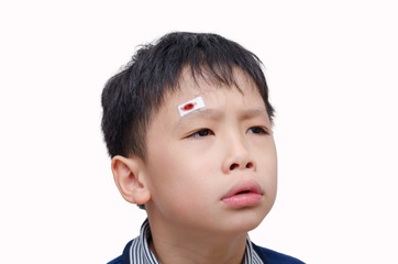 Asian boy with wound on head cover by plaster over white backgro