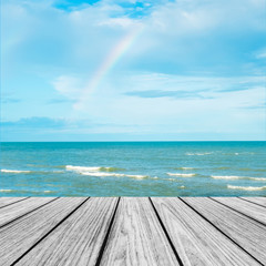 Wood Terrace on The Beach with Blue Sea and Sky with Rainbow after Raining