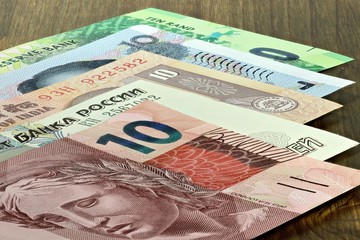Banknoten der BRICS Staaten auf Holzhintergrund