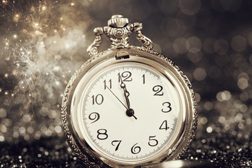 Fototapeta na wymiar Old watch pointing midnight - New Year concept