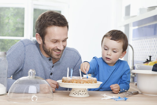 Germany, Bavaria, Munich, Father and son Years preparing birthday cake