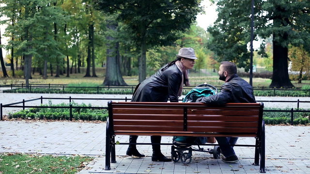 Happy couple, parents meeting in the park
