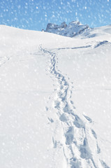 Fototapeta na wymiar Footsteps on the snow. Melchsee-Frutt, Switzerland