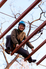 Happy woman enjoying activity in a  rope park