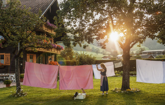 Austria, Radstadt, Farm, Female farmer hangs the washing on the line