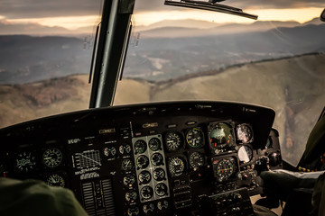 Flying in sunset over mountains in cockpit