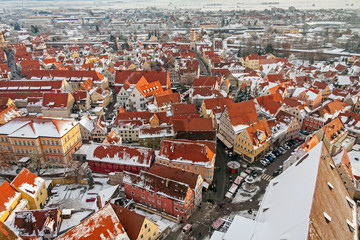 Winter panorama of medieval town within fortified wall. Top view from 