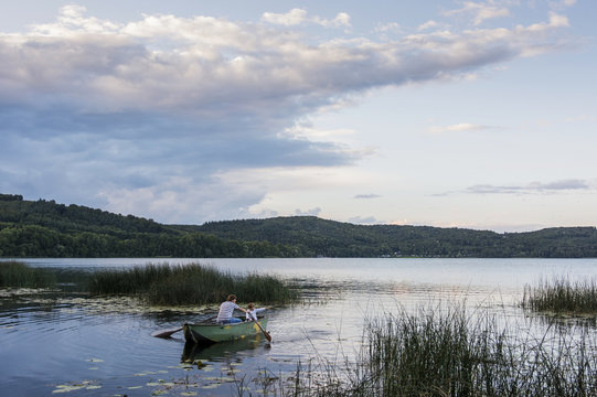 Germany, Rhineland-Palatinate, Laacher See, father and son in rowing boat