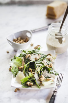 Caesar Salad with roasted cashews on plate