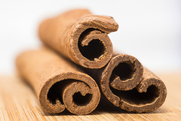 Cinnamon sticks and cinnamon powder in wooden scoop