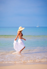 Fototapeta na wymiar Beautiful Girl With White Scarf on The Beach. Travel and Vacatio