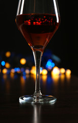 Wine glass with bokeh on dark background
