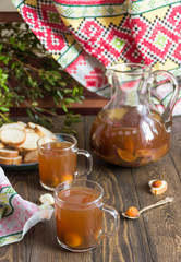 compote of apricots and apples on wooden table in the Russian style