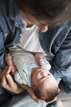Young father holding his newborn son