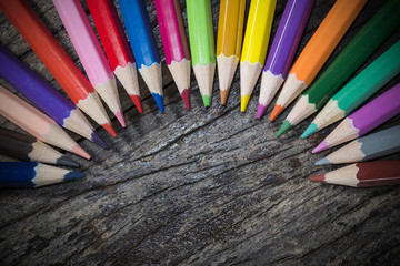 Colorful pencil on wood background