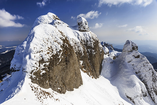 Alpine panorama with snow covered cliffs