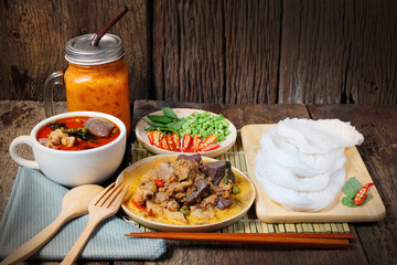 (Kanom jeen) Noodles and Chicken curry with vegetable on wood ba