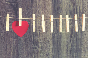 Love concept. Red heart hanging on a clothesline