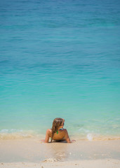 Fototapeta na wymiar Woman relaxing on the idylic beach