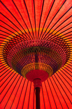 Red waxed paper and bamboo umbrella in a temple garden, Kyoto, Japan