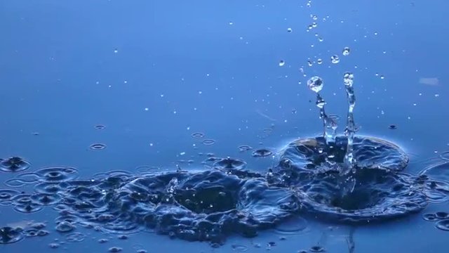 Group of boulders thrown into the calm blue water. Slow motion. Superb moving background with meditative effect. Relaxing view of the calm water. Full HD footage 1920x1080.
