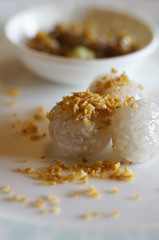 Thai dessert - glutinous rice and sago balls with dipping sauce.