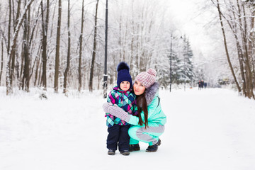Fototapeta premium happy family mother and child baby daughter on a winter walk in the woods
