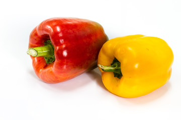 colored peppers over white background