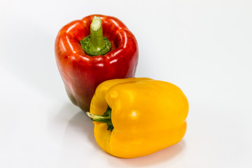 colored peppers over white background