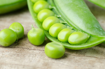Fresh green pea on wooden background