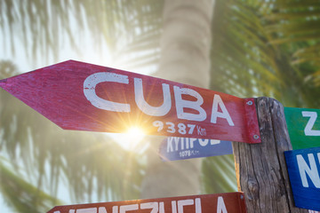 Signs  showing distances to major countries on the tropical beac