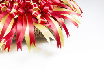 Gold and red ribbons with bow and space for text on white backgr