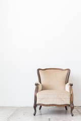 vintage armchair on white wall.