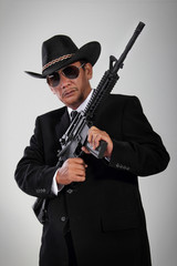 Old gangster portrait with machine gun