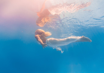 Young woman swimming underwater