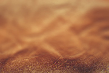 Soft focus, blurred brown leather texture for background.