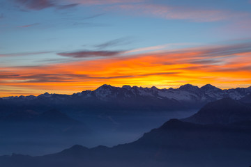 Obraz na płótnie Canvas Mountain silhouette and stunning sky at sunset