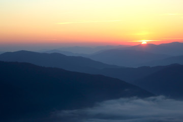 Fototapeta na wymiar mountains in the mist before sun dawn