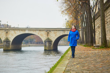 Beautiful young tourist in Paris on a fall or spring day