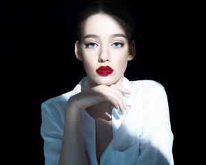 Portrait of a beautiful sensual brunette girl with red lips / close-up of an attractive girl of the...