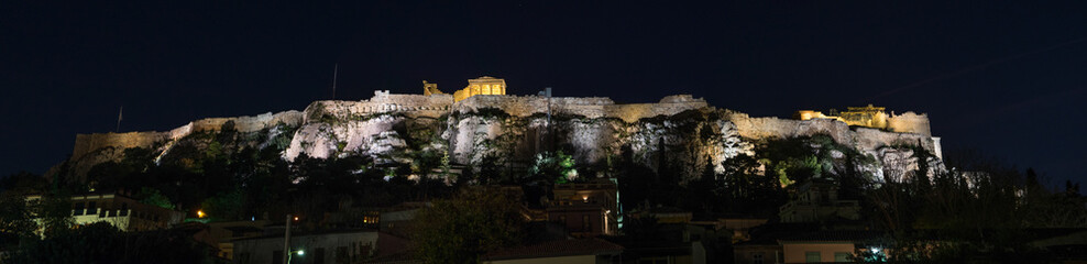 Night panorama of the Athens, Greece Acropolis with the Parthenon and other ancient ruins illuminated