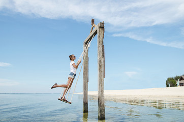 Happy girl on a swing - stock image