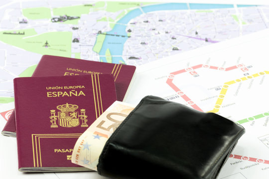 Spanish passport with european union currency in a wallet and map as a background

